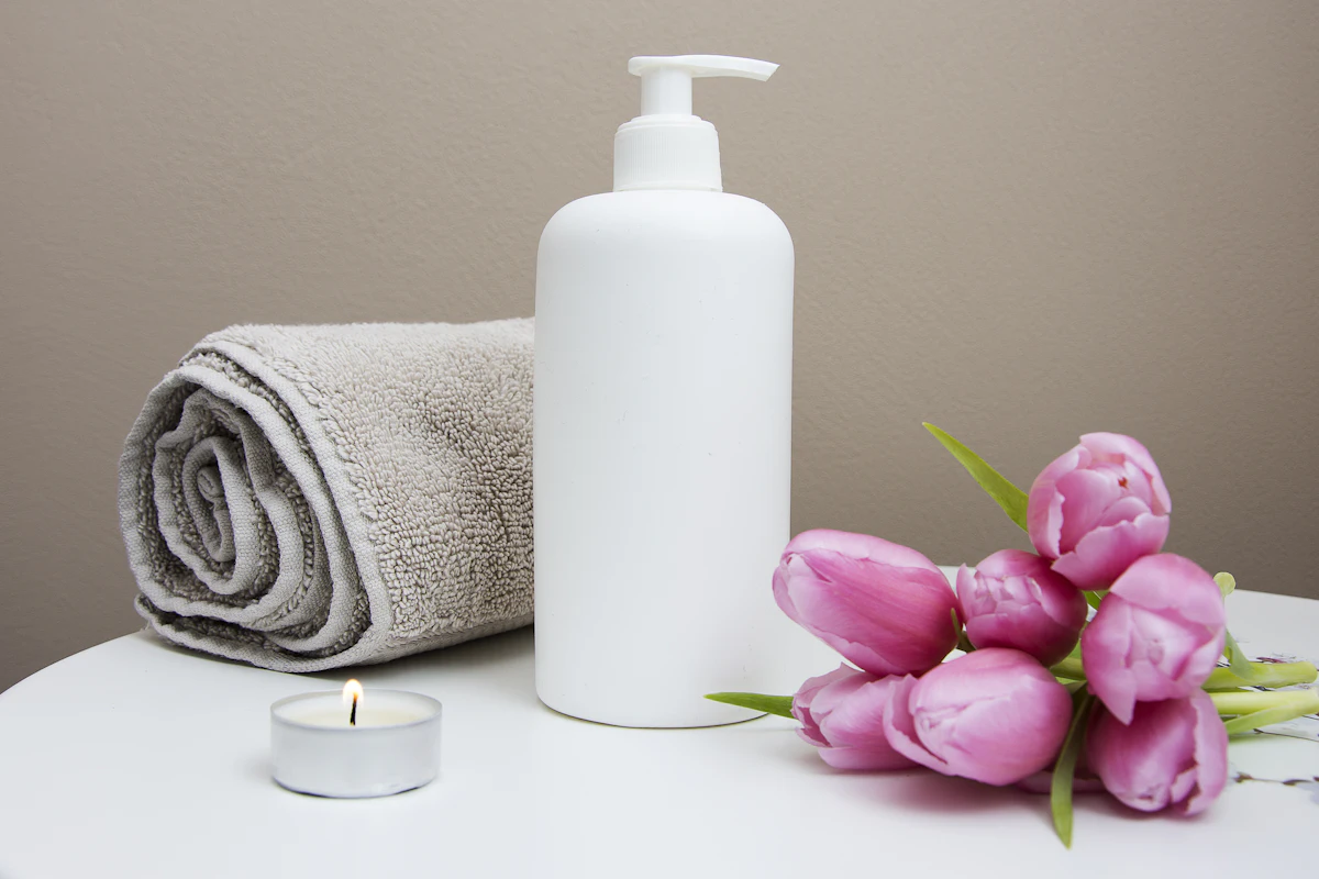Quiet spa still life with folded towels and soft candlelight at Yoshino Massage in Arlington, TX